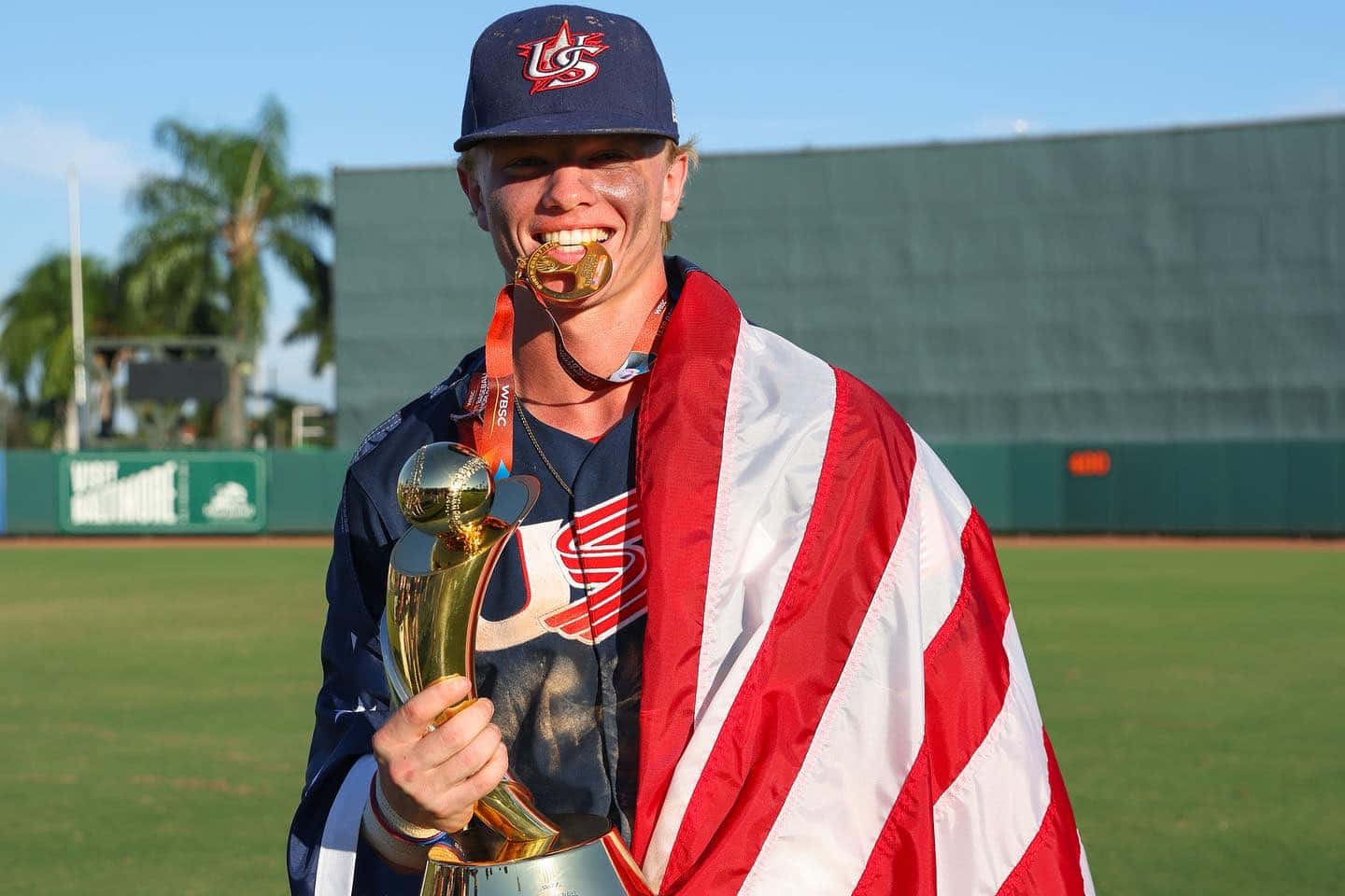 Baseball Player Celebrating Victory With Trophy And Flag Wallpaper