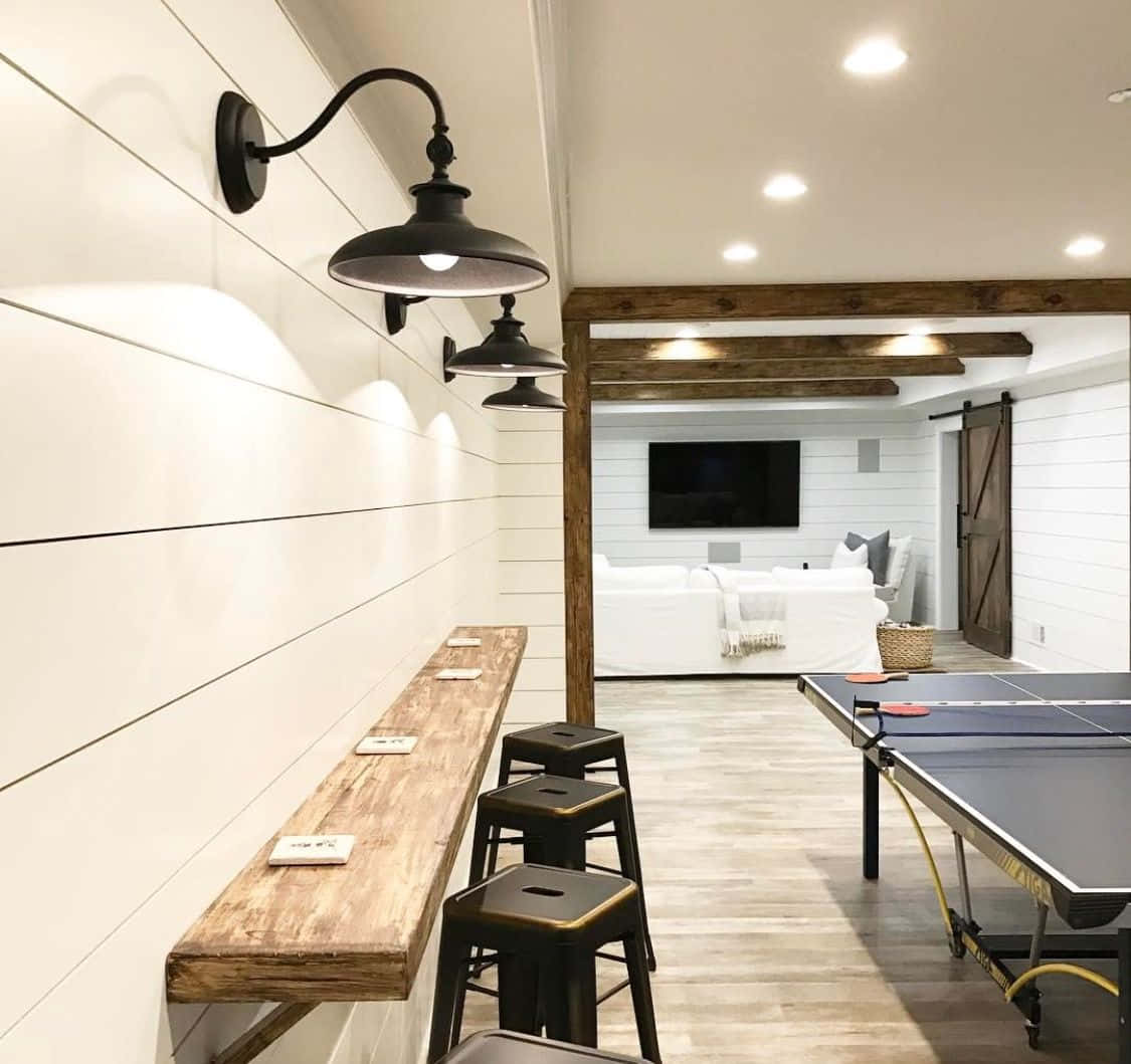 A Basement With Ping Pong Table And Stools