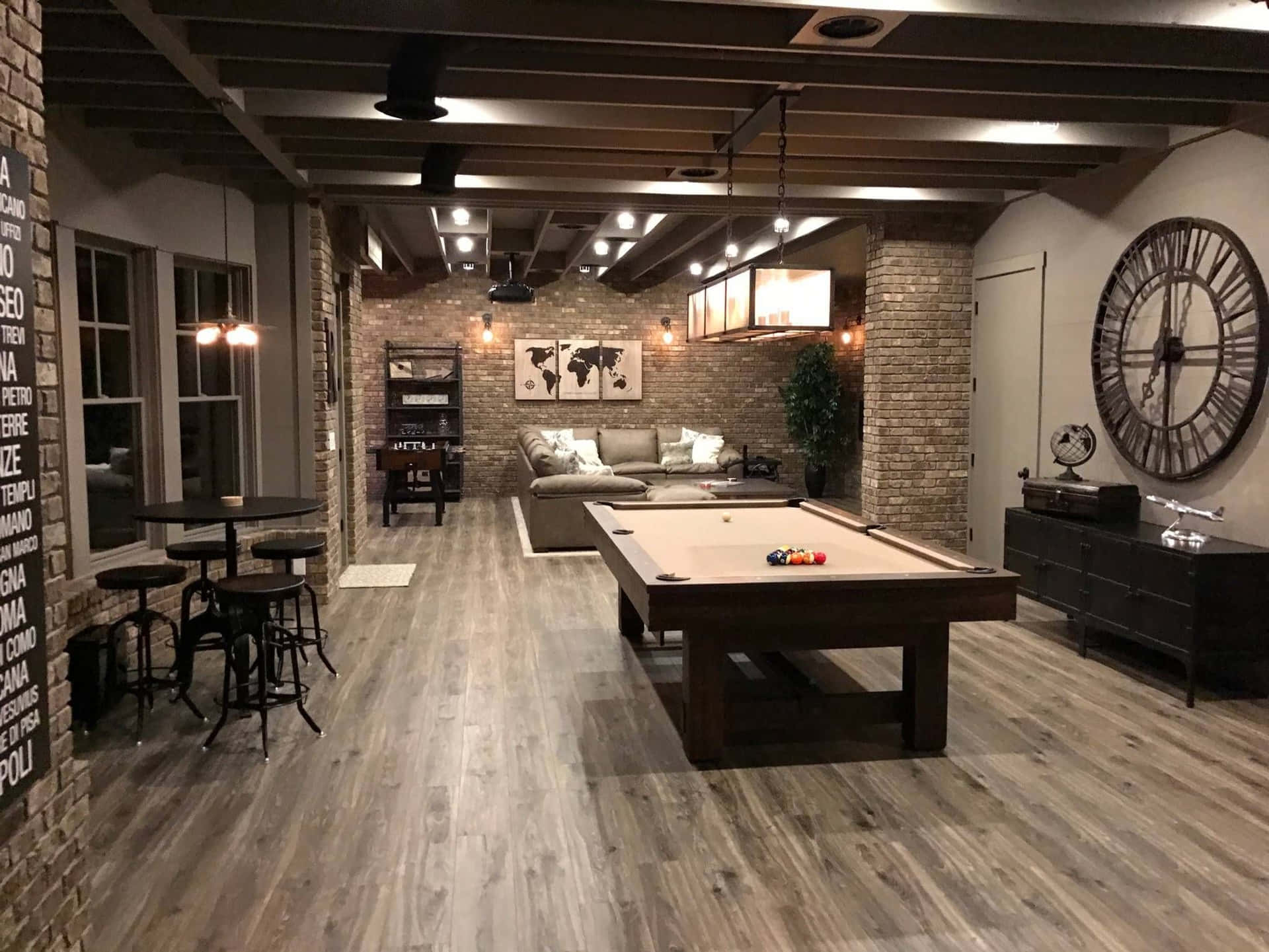 A Basement With A Pool Table And A Clock