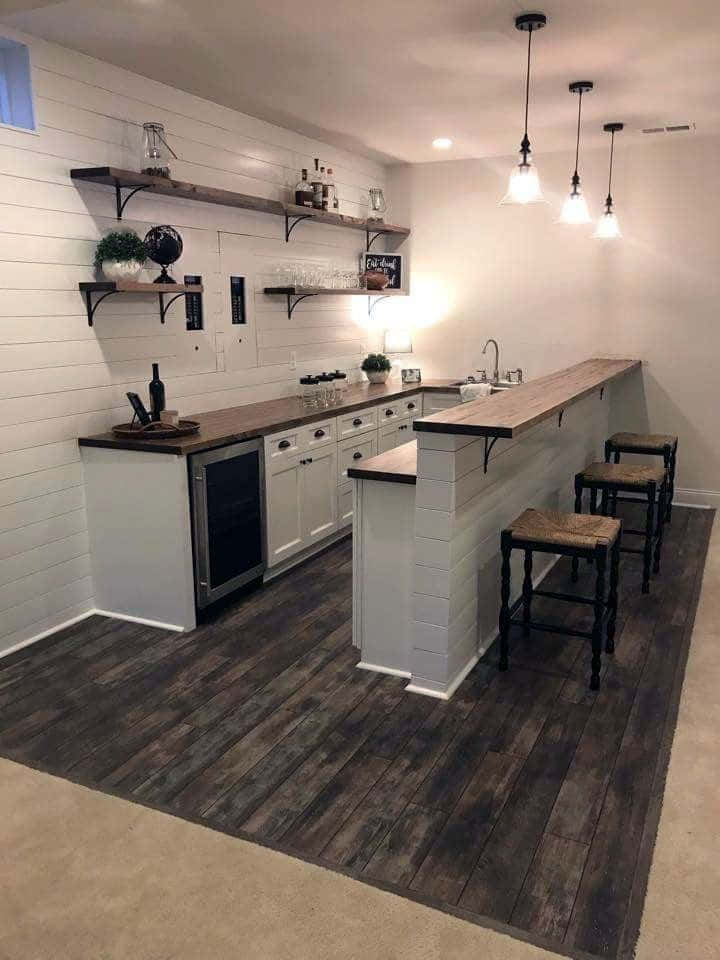 A Kitchen With A Bar And Stools