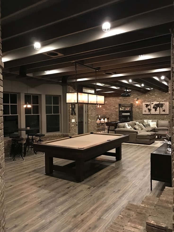 A Large Basement With A Pool Table And Couches