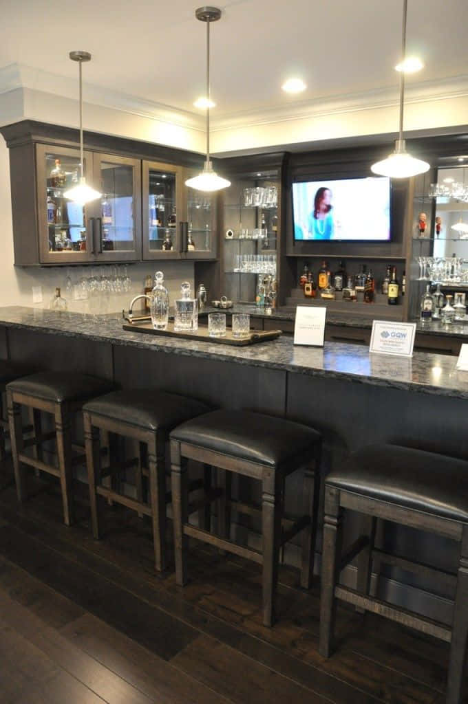 A Home Bar With Stools And A Television