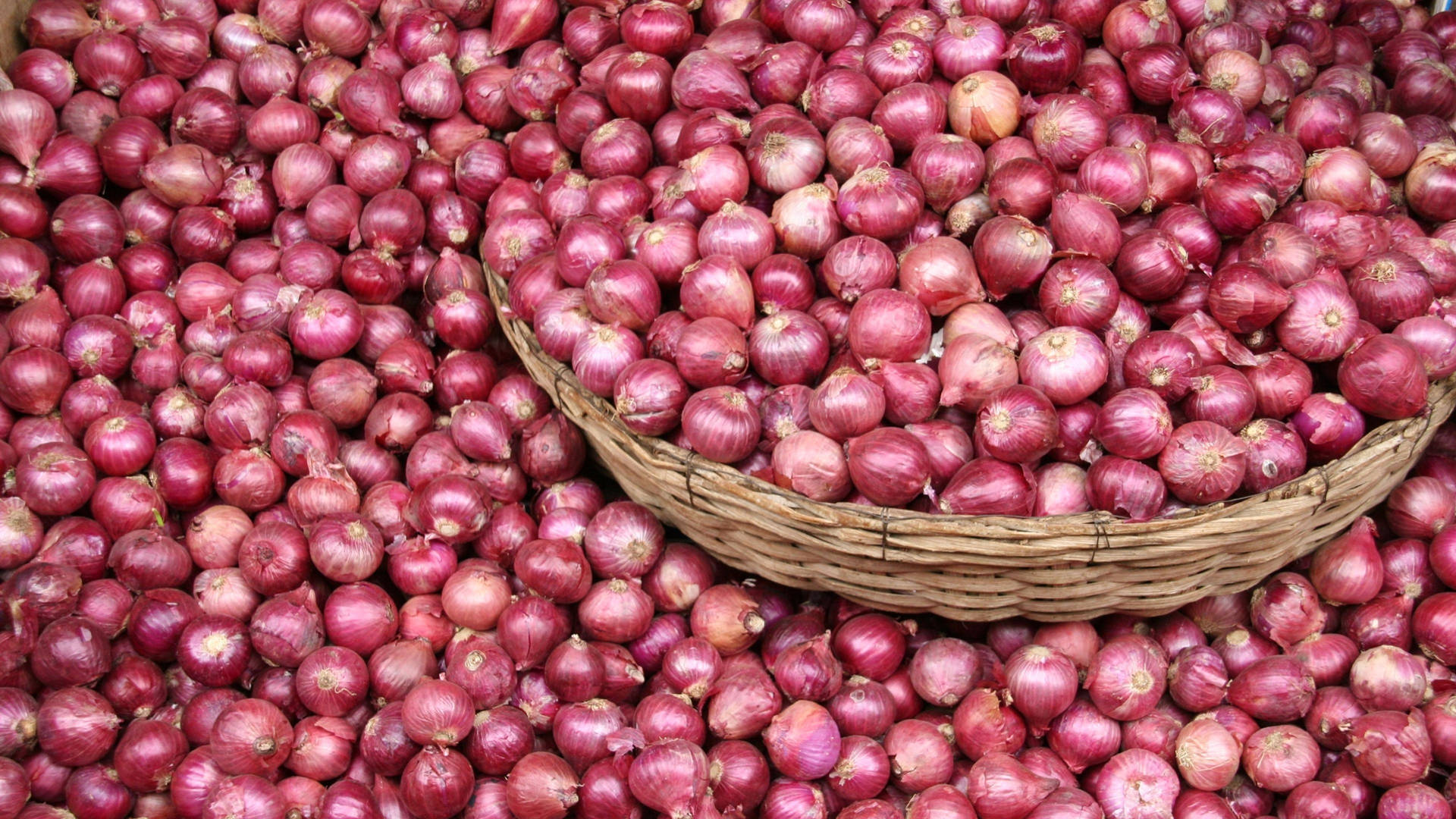 Basket With Harvested Stock Of Red Onions Wallpaper
