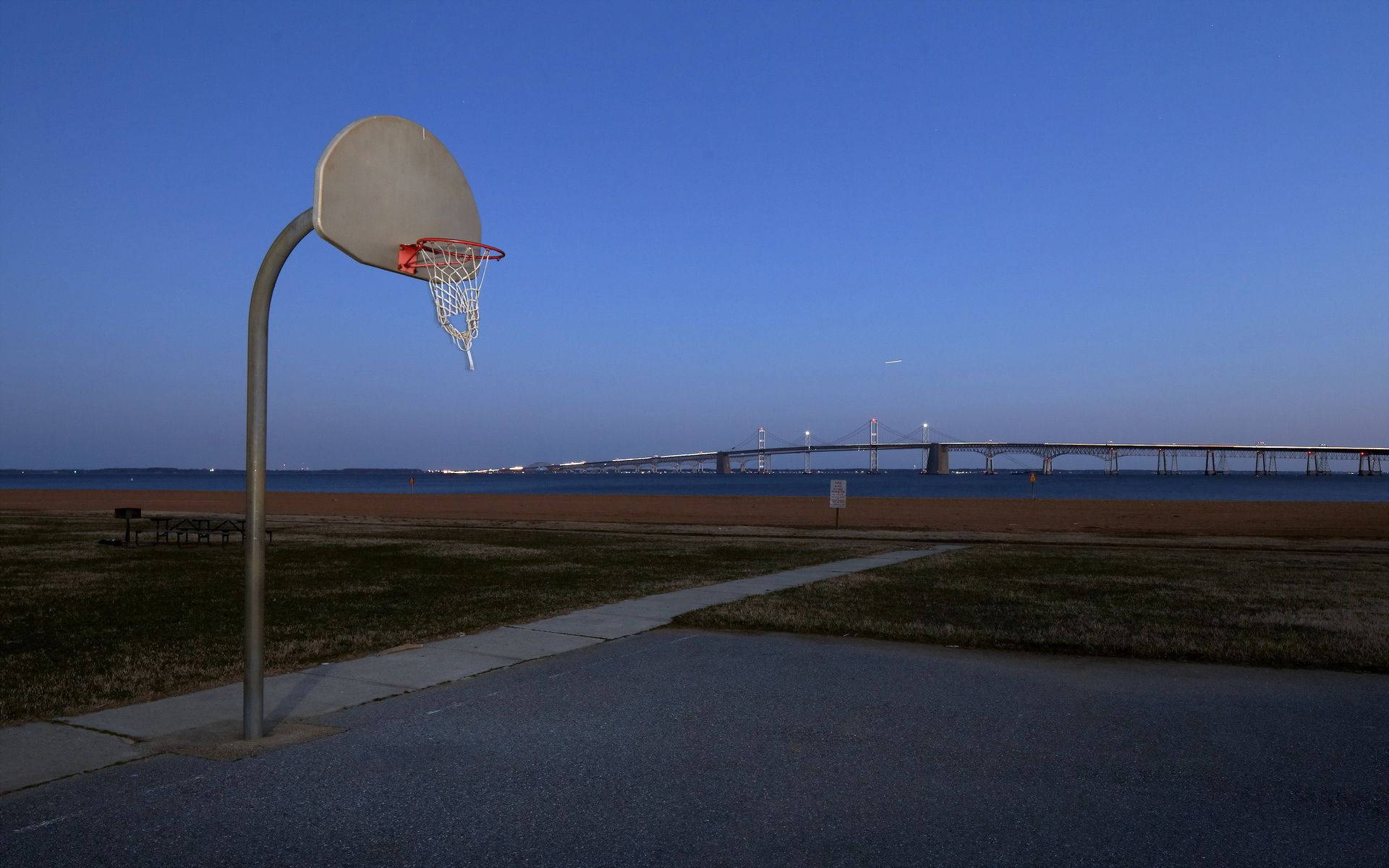 Basketball Court With Bridge On River Wallpaper