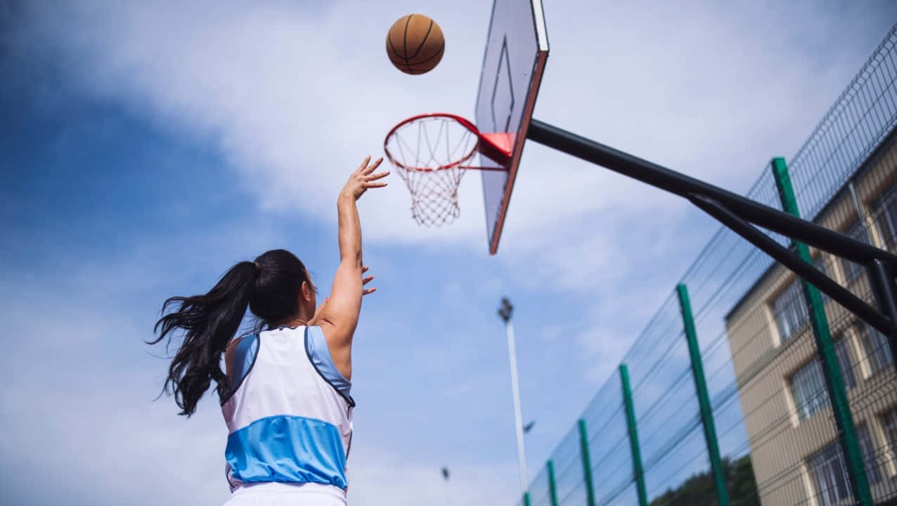 Basketball Girl Shooting Hoop Outdoor Court.jpg Wallpaper
