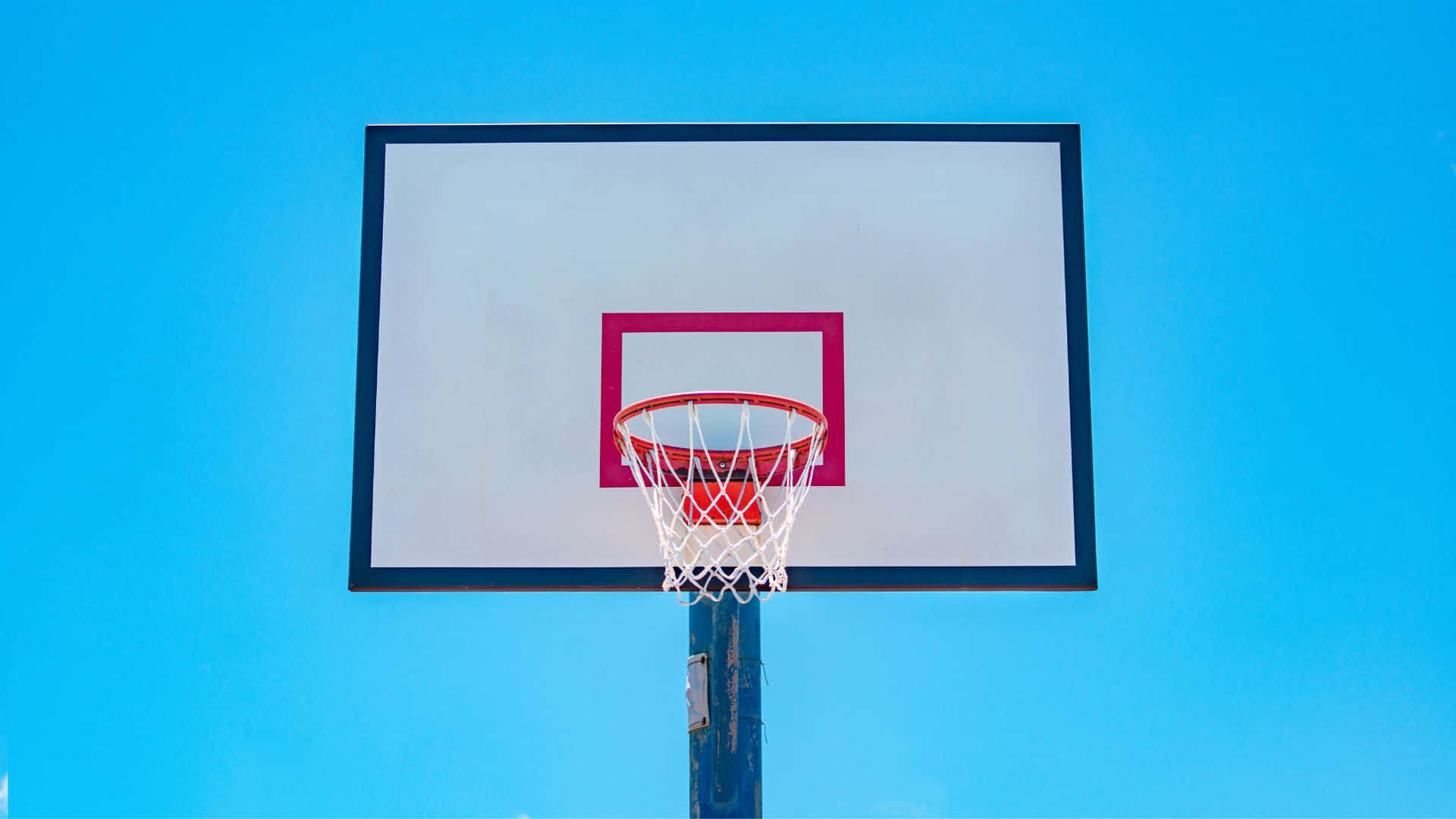 Basketball Hoop Against Blue Sky Wallpaper