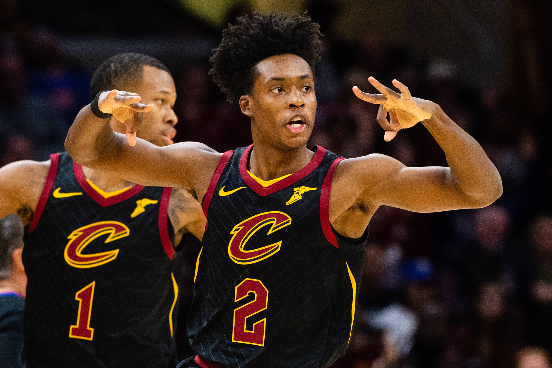 Collin Sexton Making a Three-Point Sign in a Basketball League. Wallpaper