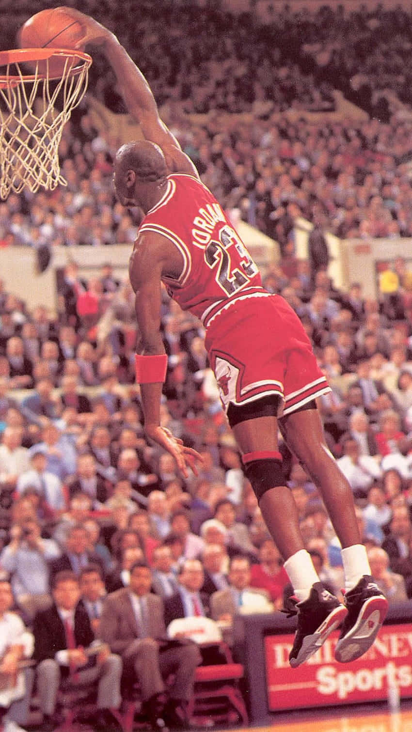 Download Michael Jordan flies through the air making a legendary dunk  Wallpaper