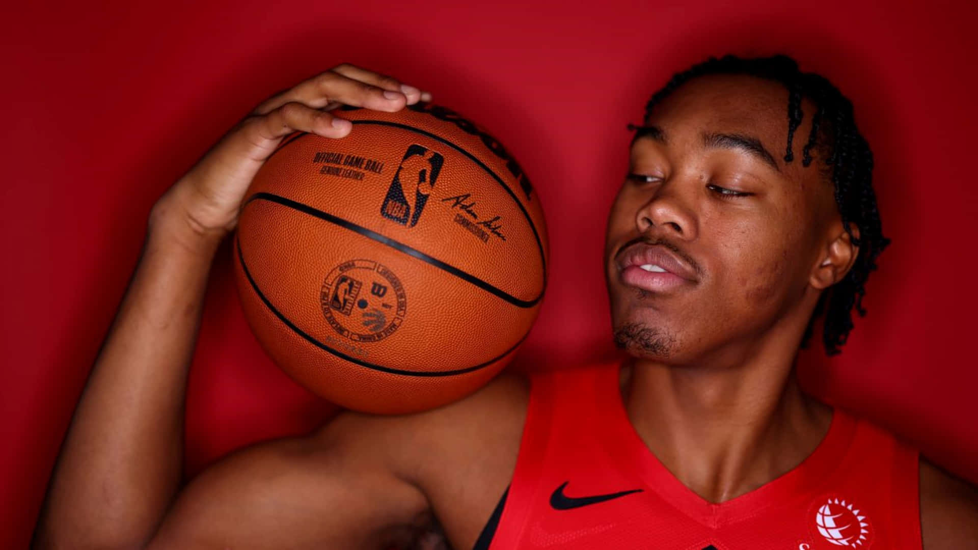 Basketball Player Contemplative Posewith Ball Wallpaper