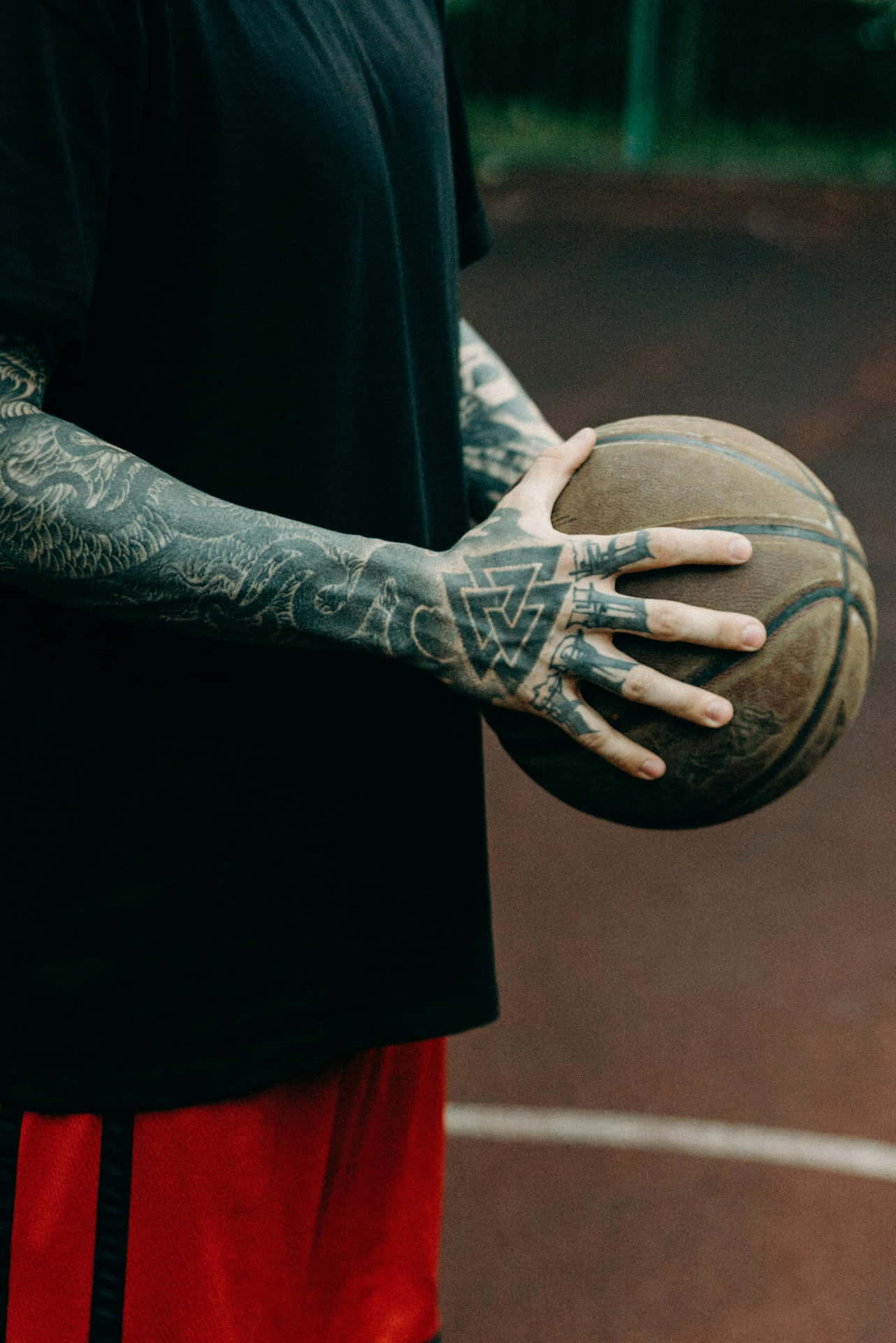 Basketball Player Holding Ball Tattooed Arm.jpg Wallpaper