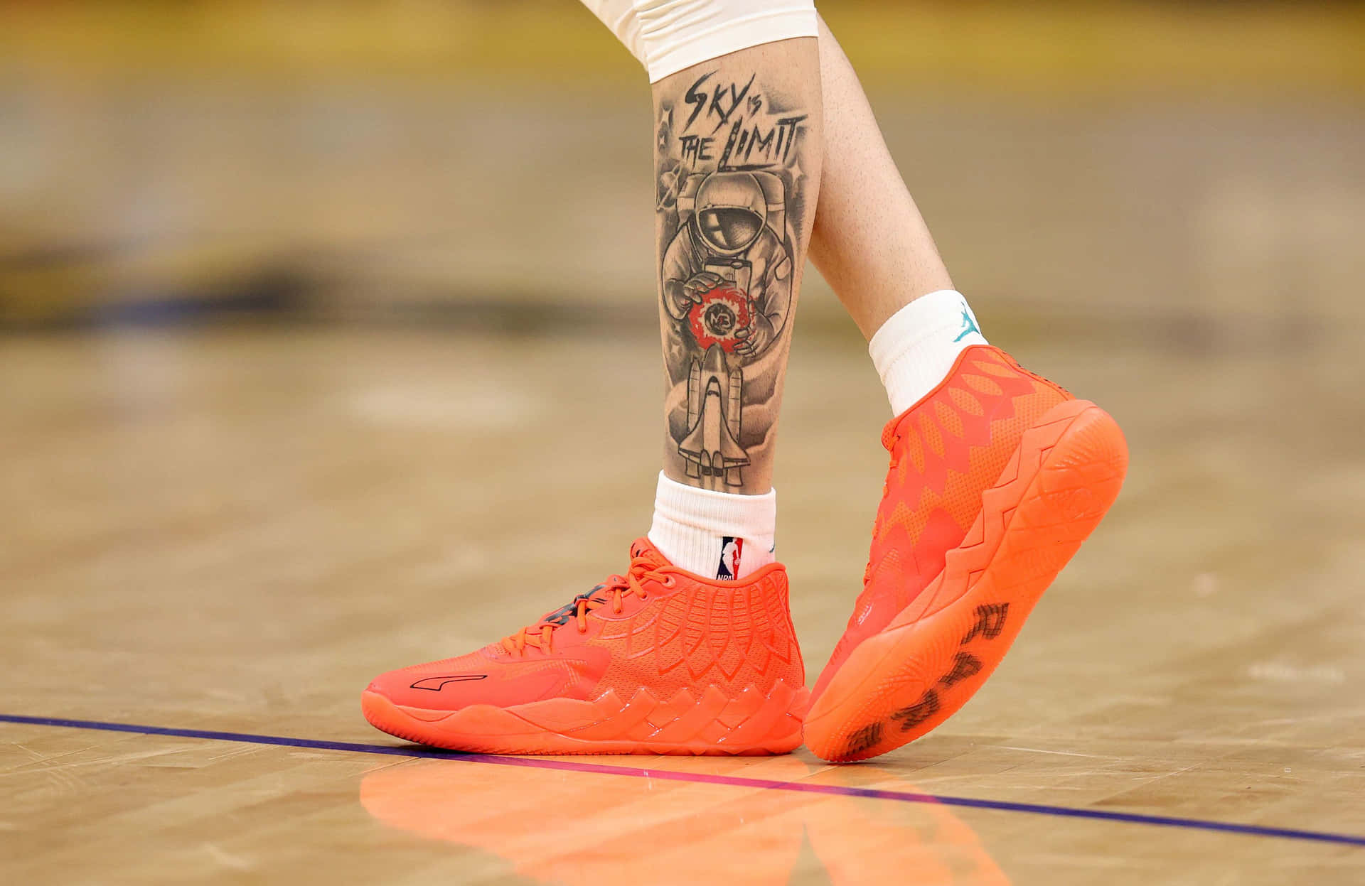 Basketball Player Leg Tattooand Sneakers Wallpaper
