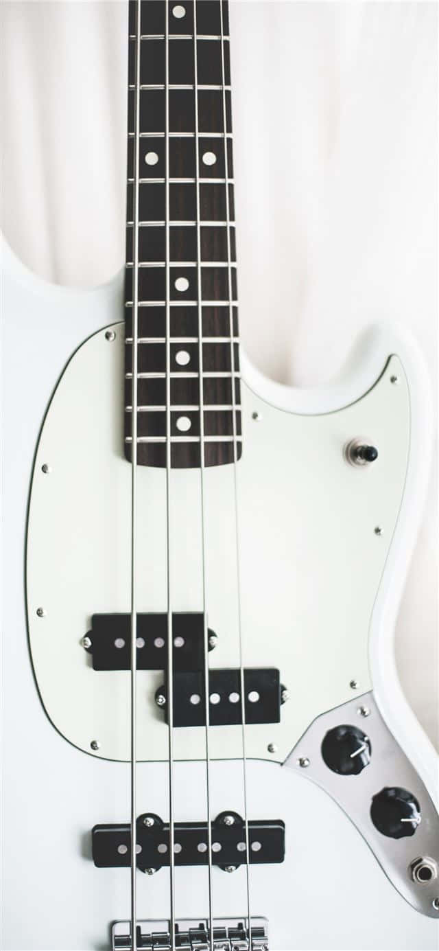 A White Bass Guitar With Black And White Strings Wallpaper