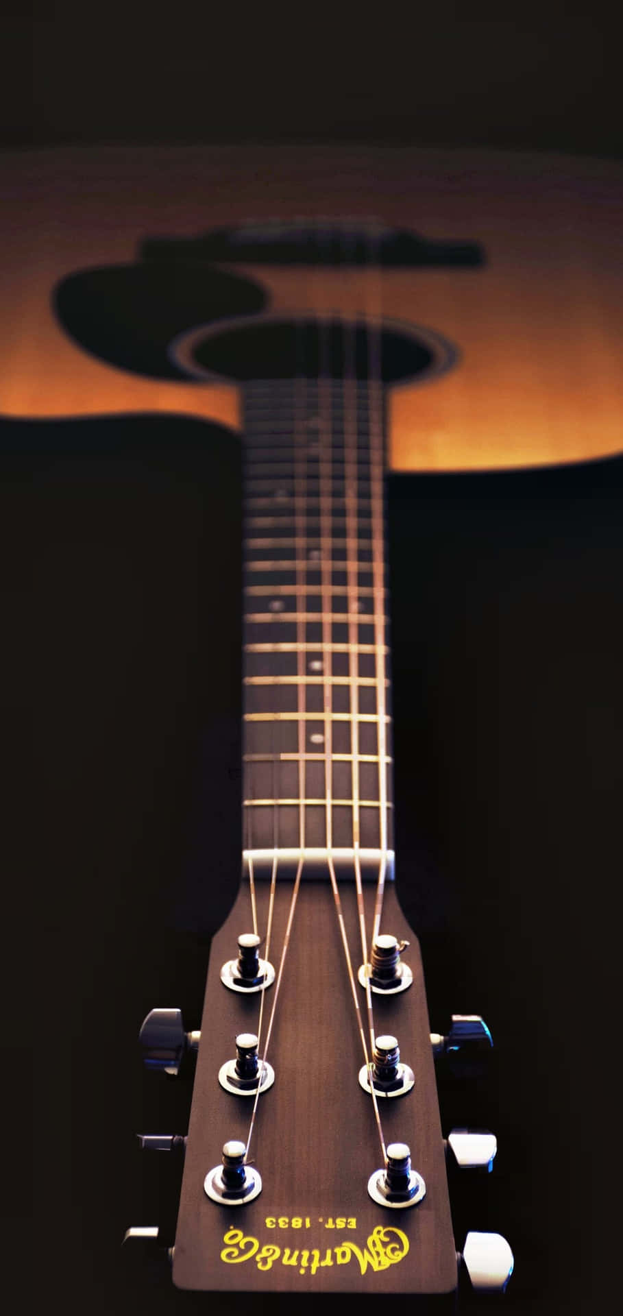 Et nærbillede af et akustisk guitar Wallpaper