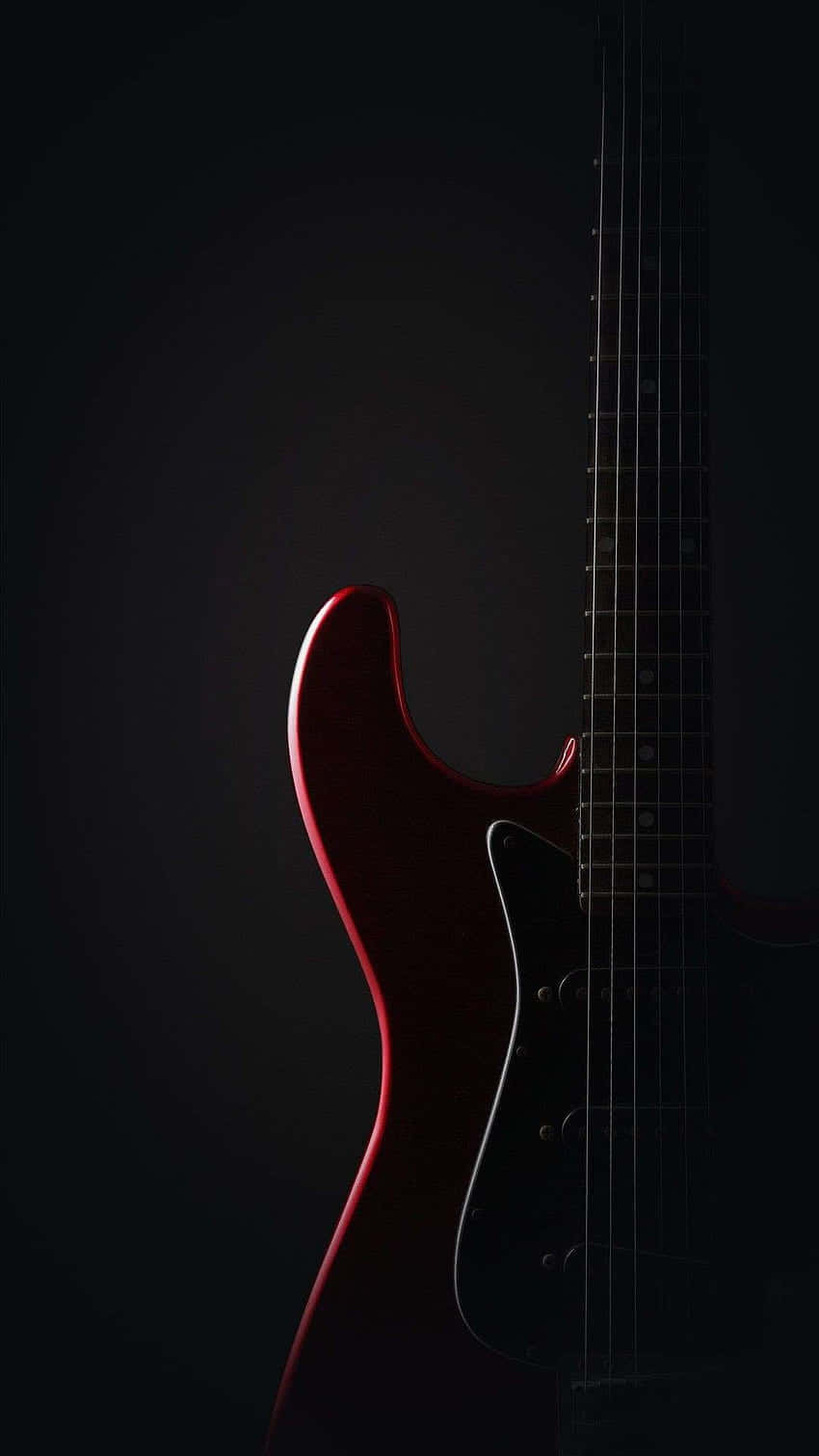 En rød elektrisk guitar bliver vist mod et sort baggrund Wallpaper