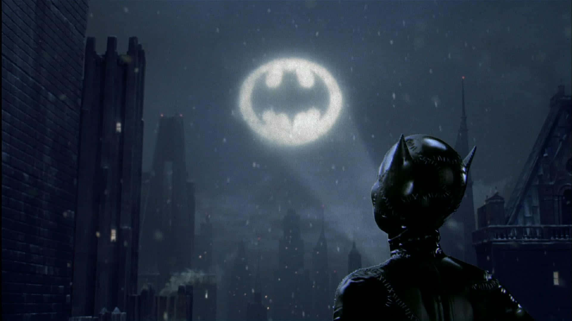 The iconic Bat-Signal illuminating the night sky over Gotham City Wallpaper