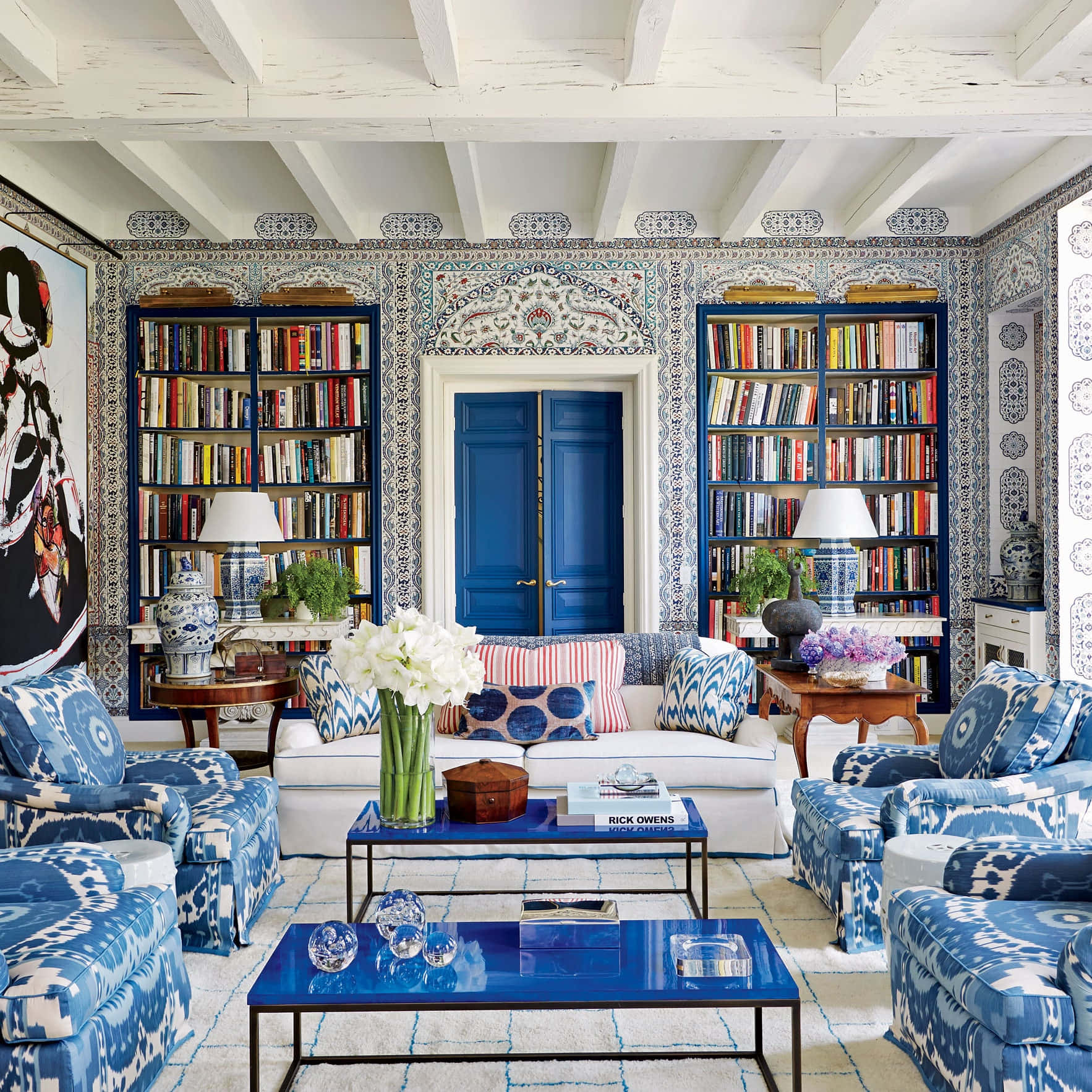 A Blue And White Living Room With Bookshelves