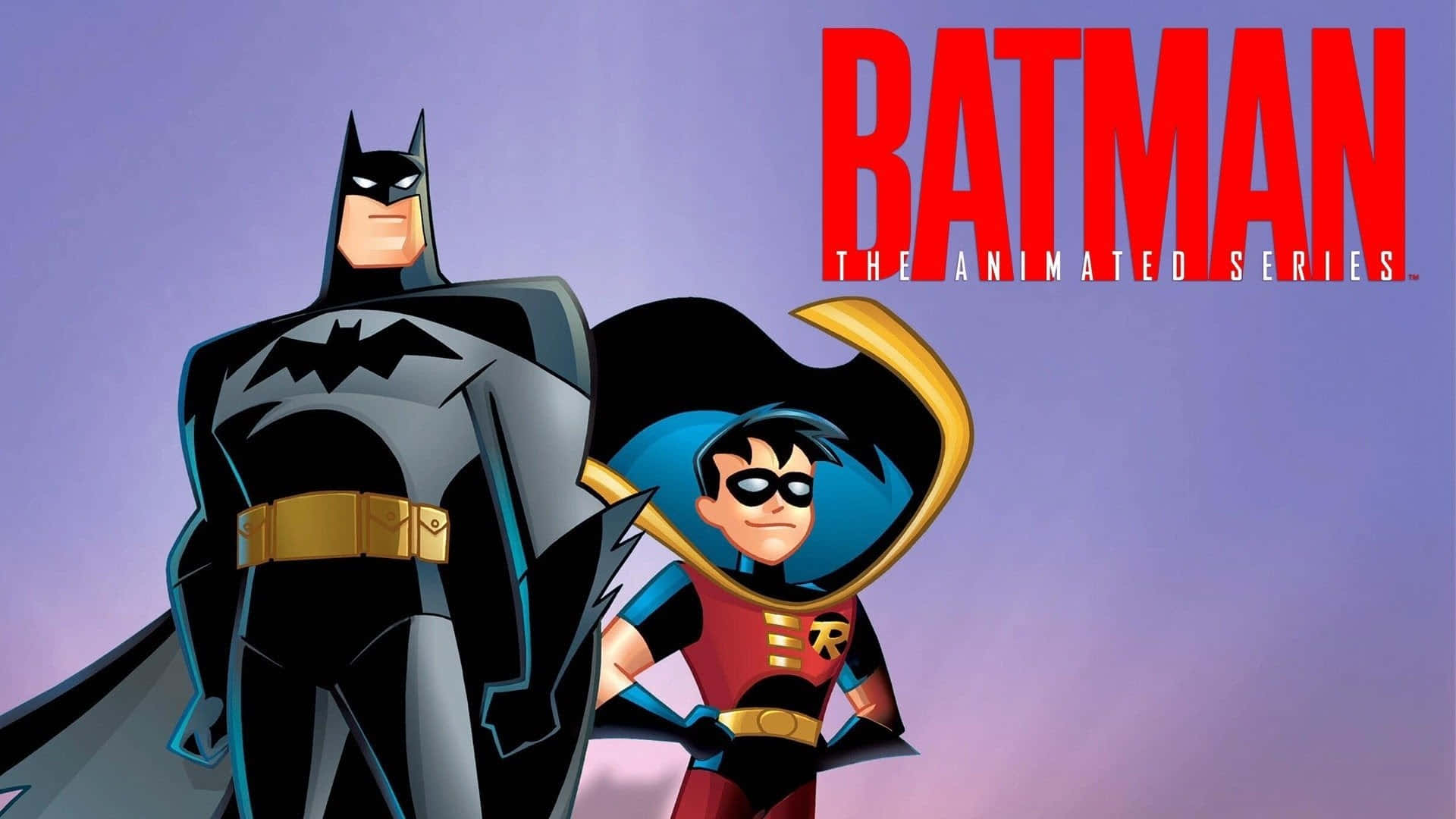Batman and Robin strike a heroic pose in Gotham City Wallpaper