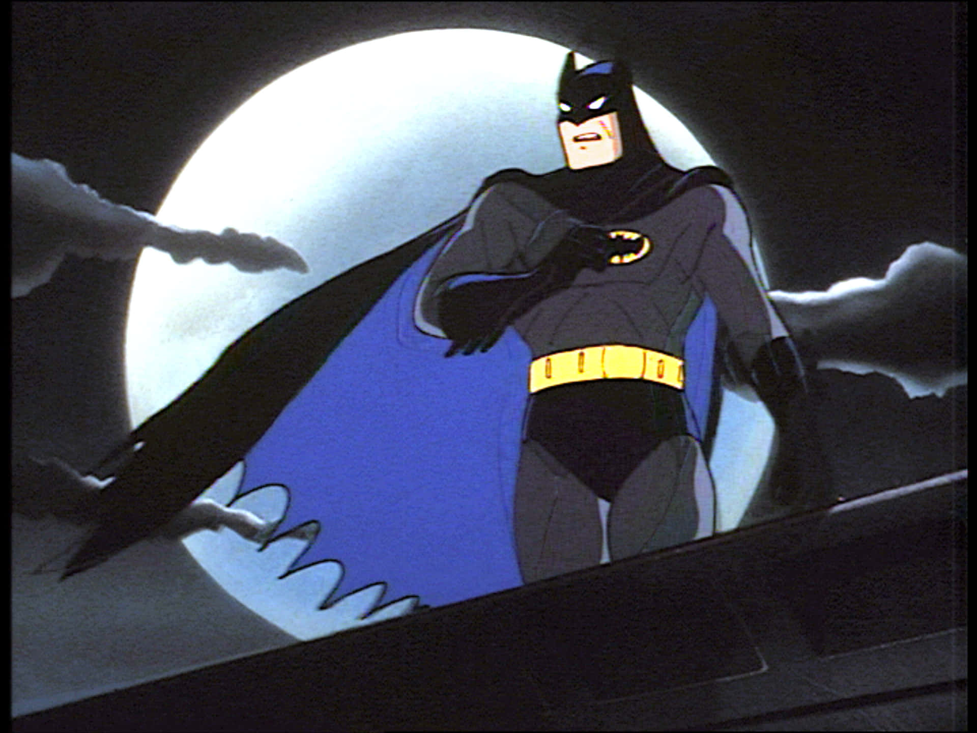 Batmande Pie En Lo Alto De Un Edificio De La Ciudad, Con Vistas A Gotham City En Batman Animated Adventures. Fondo de pantalla