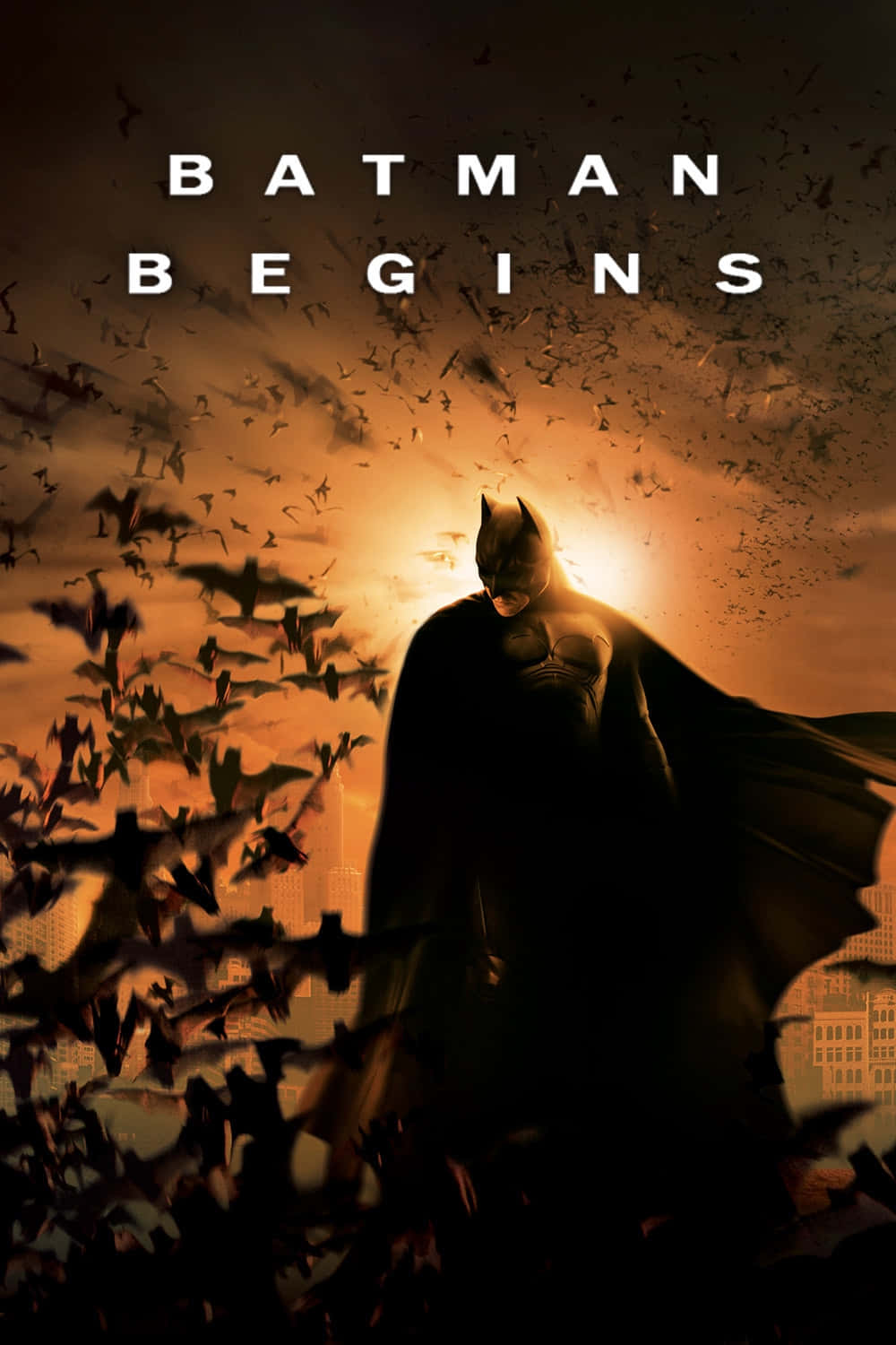 Captivating poster of Batman Begins with the bat symbol and Gotham City in the background Wallpaper
