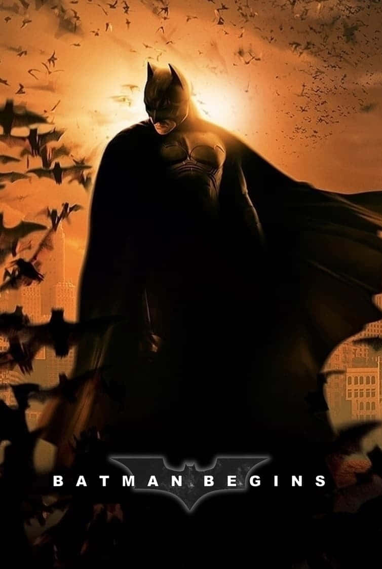 Batman stands tall in the dark rain-soaked streets of Gotham City Wallpaper