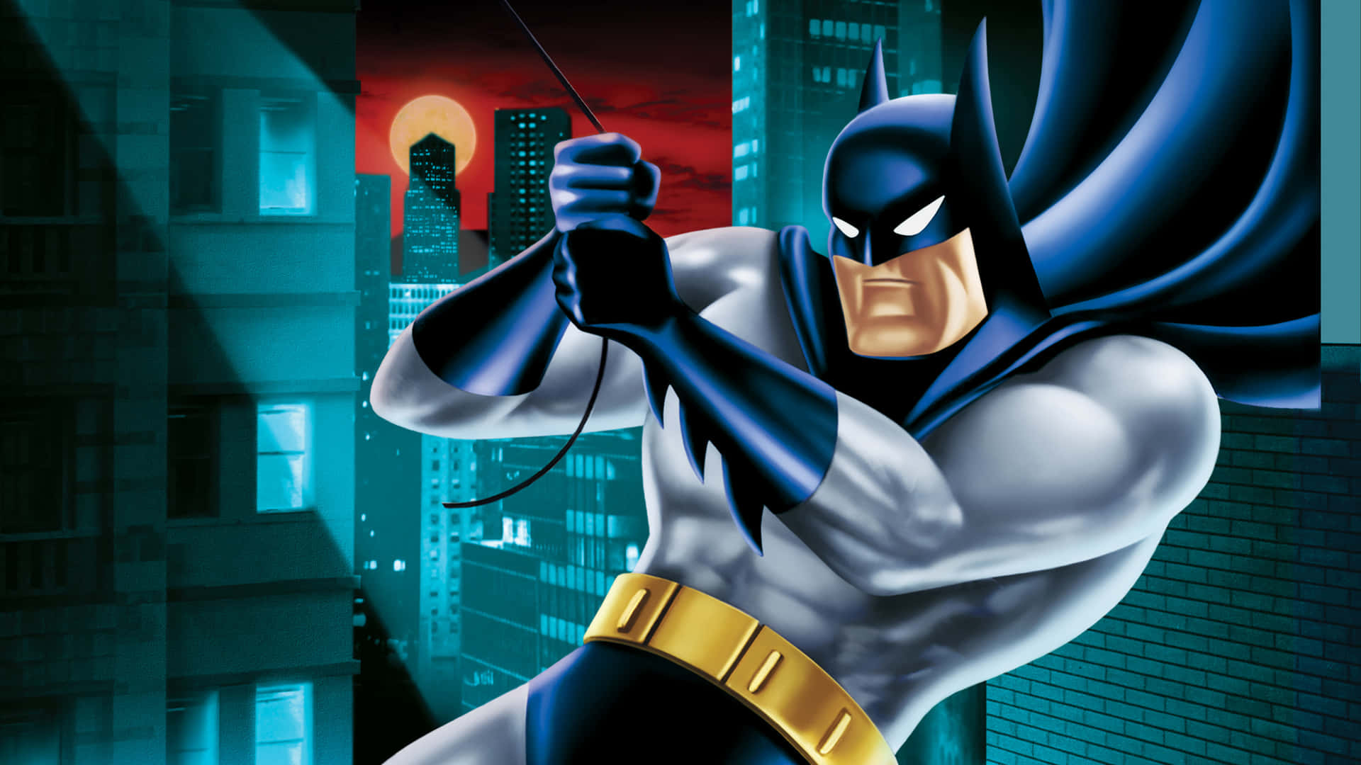 Batman soars through the night city skyline. Wallpaper
