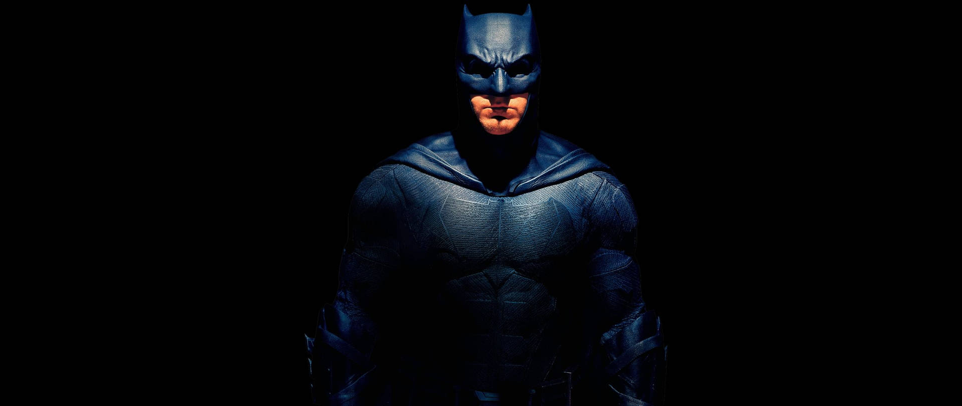 1.  Batman emerges from the shadows in this 2560x1080 wallpaper Wallpaper
