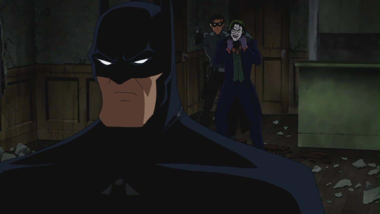 Batman confronts the Red Hood in a thrilling showdown Wallpaper