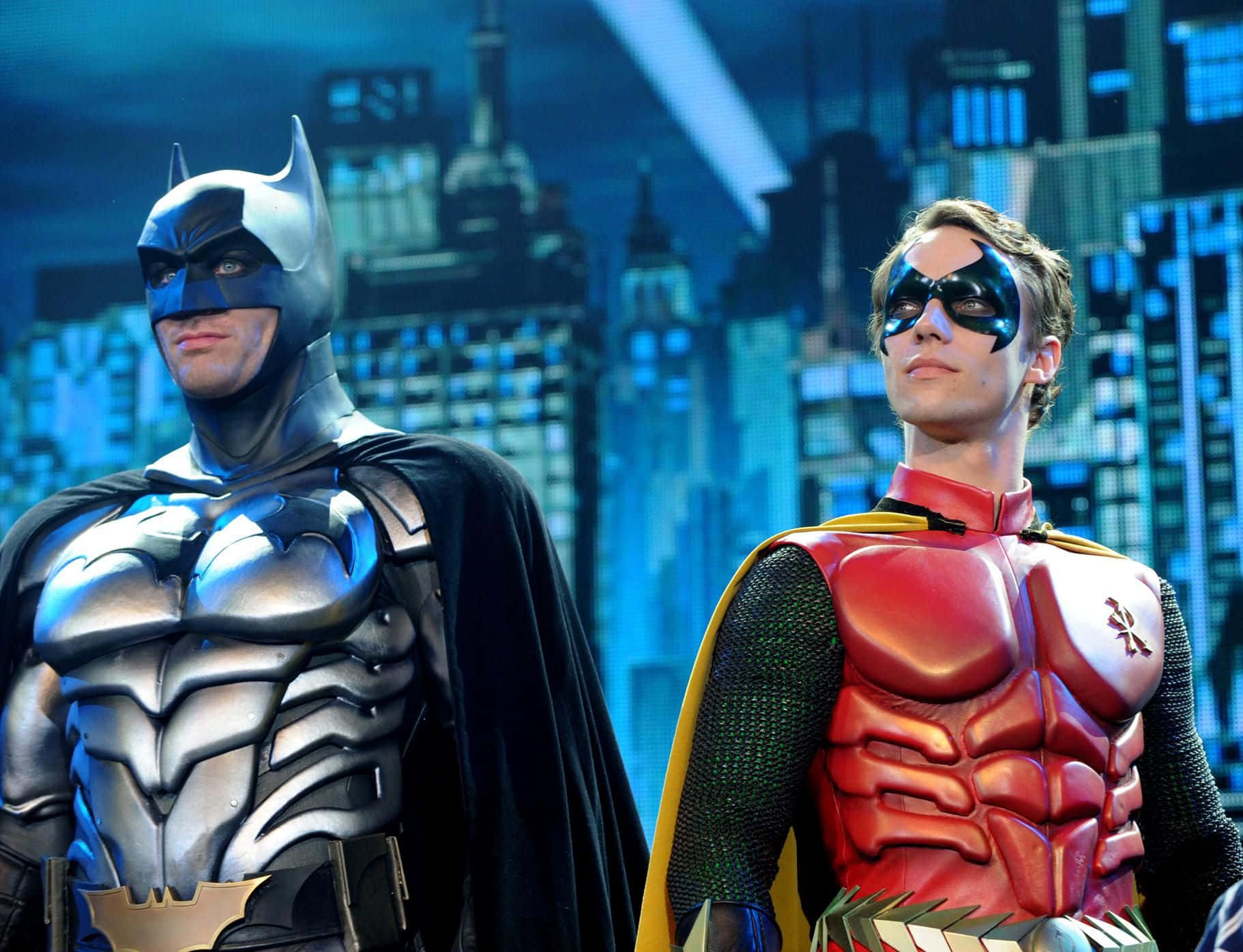 Batman and Robin Face Off in an Intense Battle Wallpaper