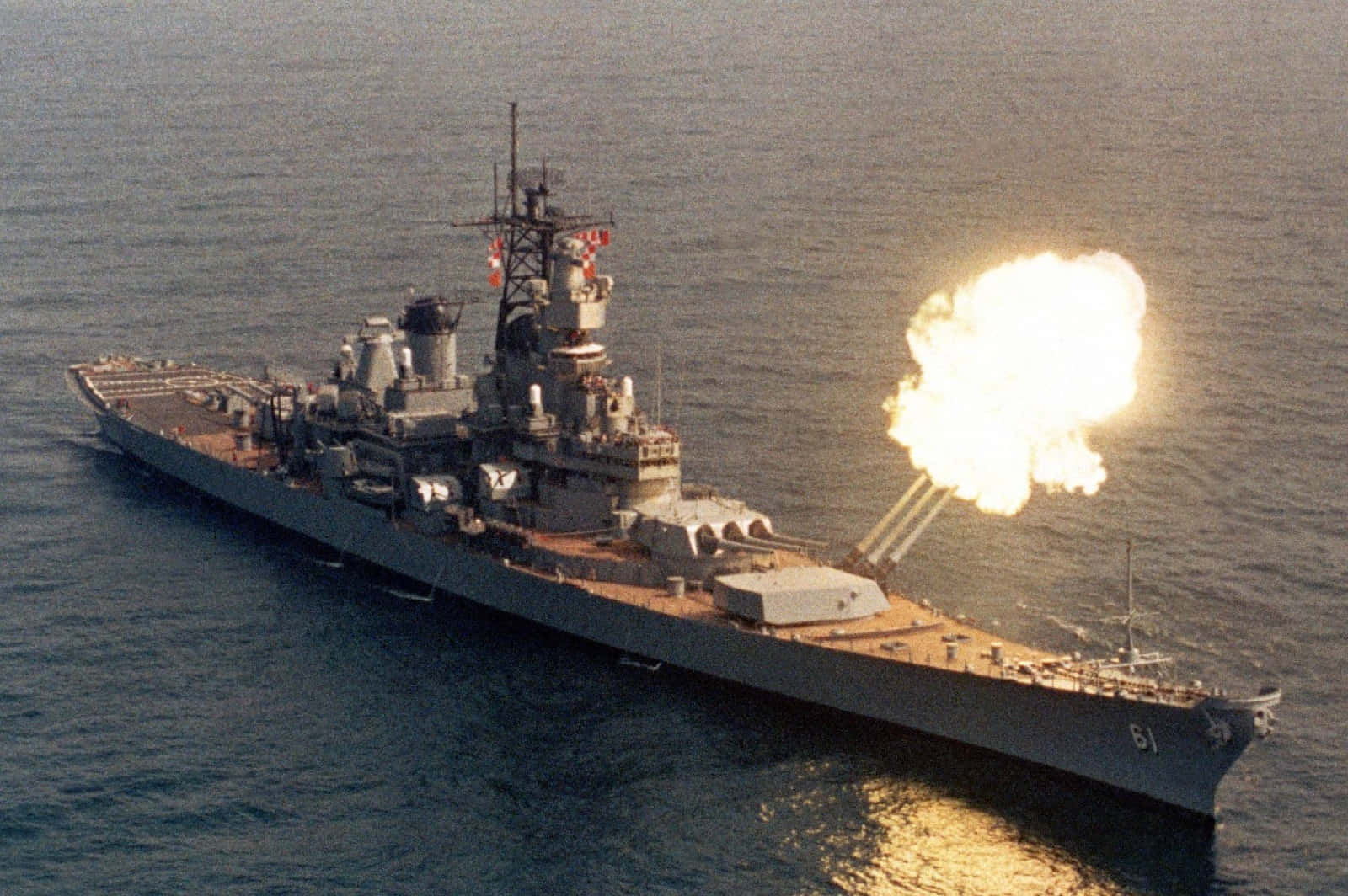 A Battleship With A Fire Hose In The Water