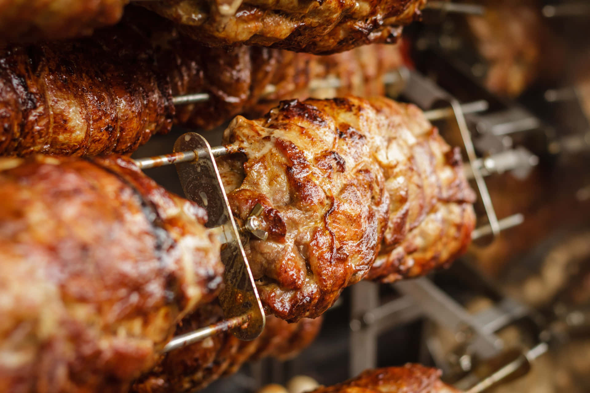 A Skewer Of Meat Hanging On A Rack