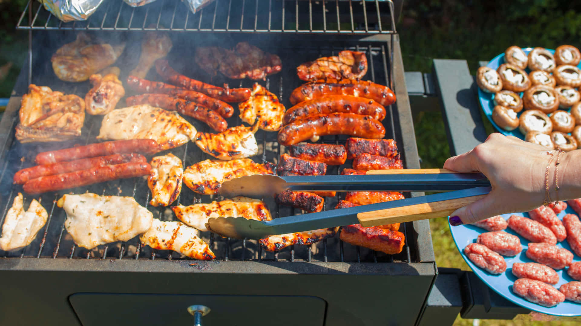 A Person Is Grilling A Lot Of Food On A Grill
