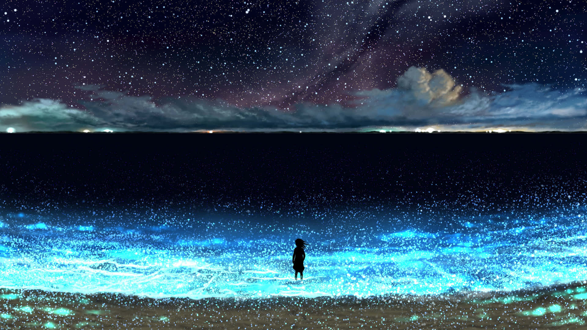 A Person Standing On The Beach Under The Stars