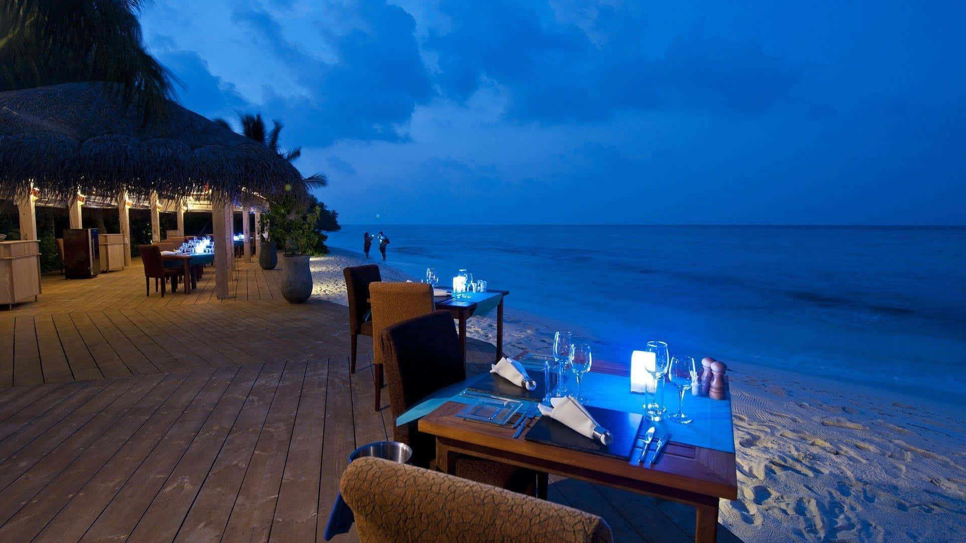 A Restaurant On The Beach At Night