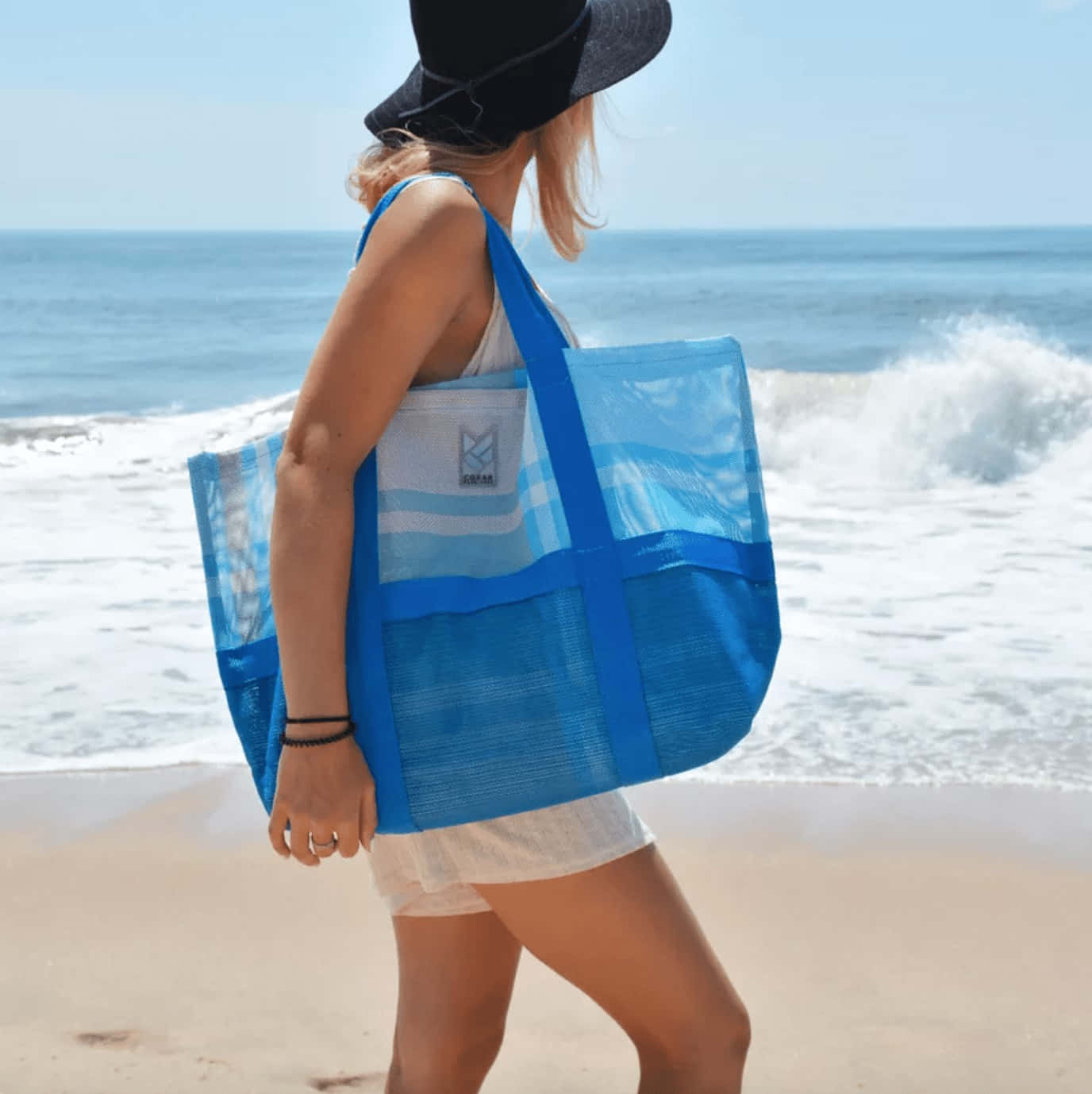 Vibrant and Stylish Beach Bag on a Sandy Shore Wallpaper