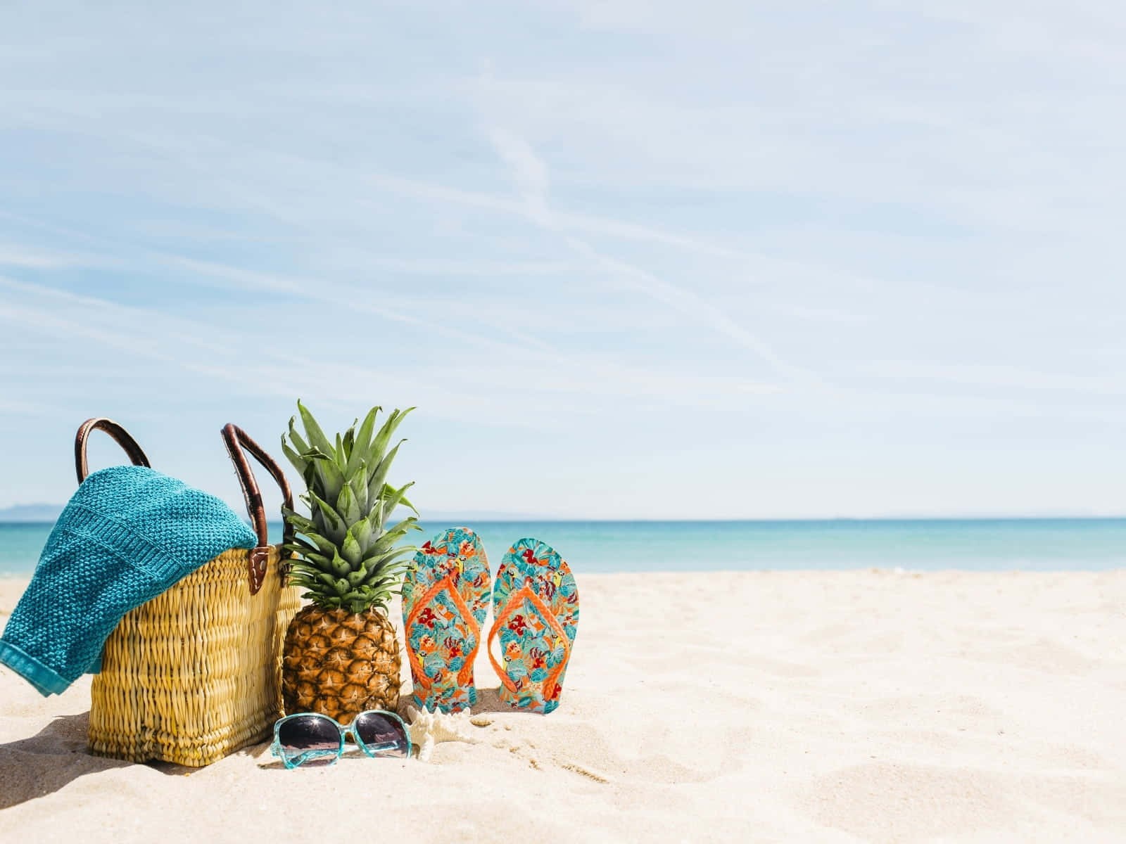 Vibrant Beach Bag Essentials on Sandy Shore Wallpaper