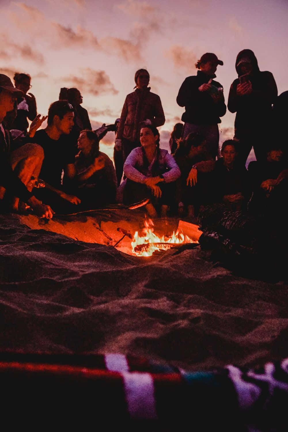 A Mesmerizing Beach Bonfire Under the Stars Wallpaper
