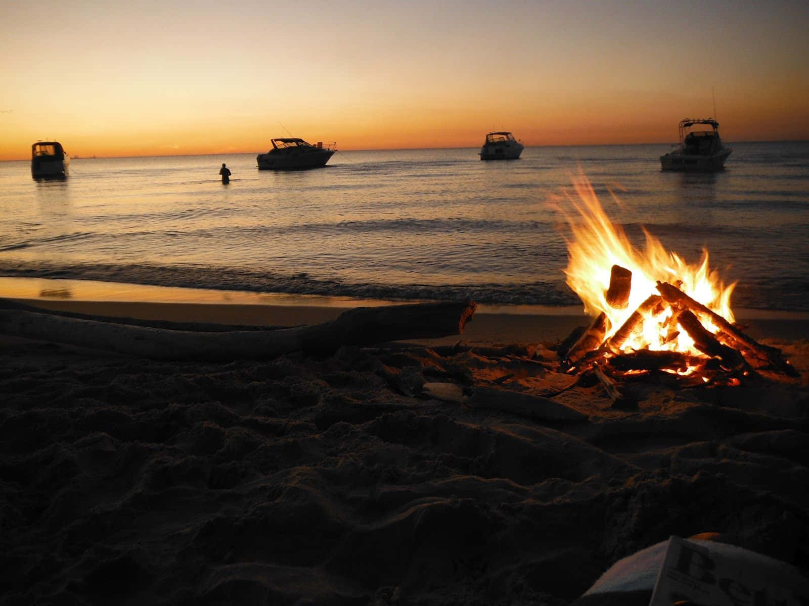 Cozy Beach Bonfire at Sunset Wallpaper