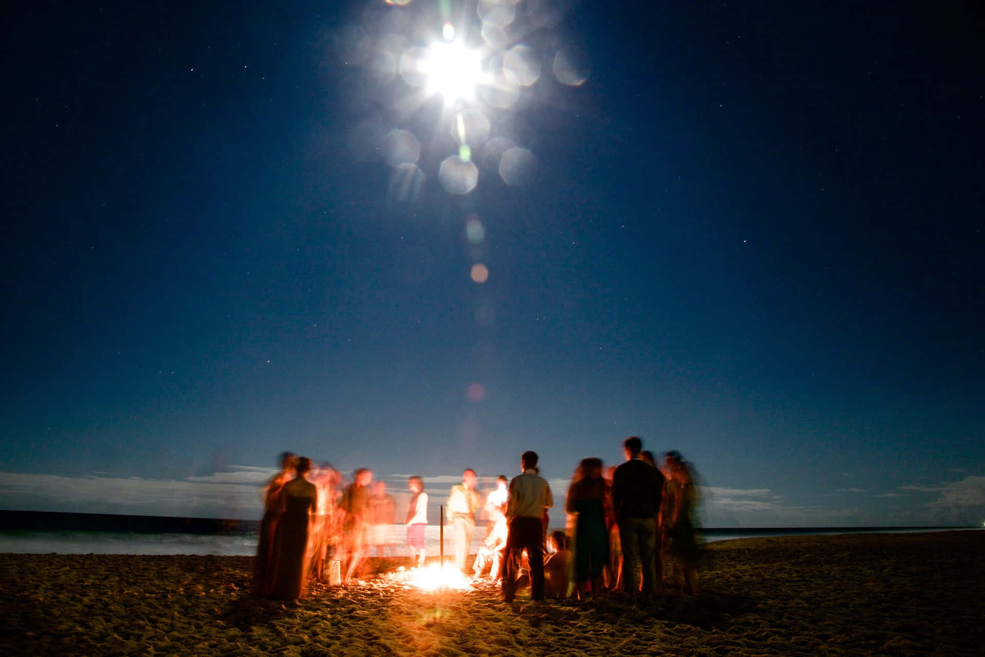 Unwinding Beach Bonfire Party Wallpaper