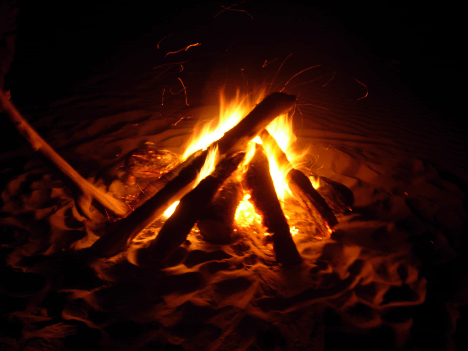 Inviting Beach Bonfire Under A Starry Sky Wallpaper