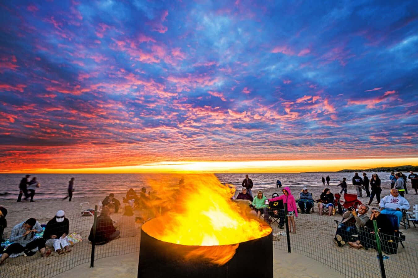 Beach Campfire Under A Stunning Sunset Wallpaper
