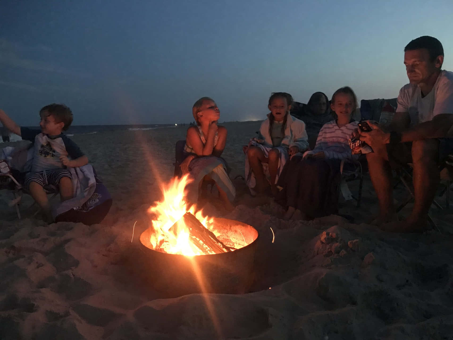 Gathering Around A Beach Campfire Wallpaper