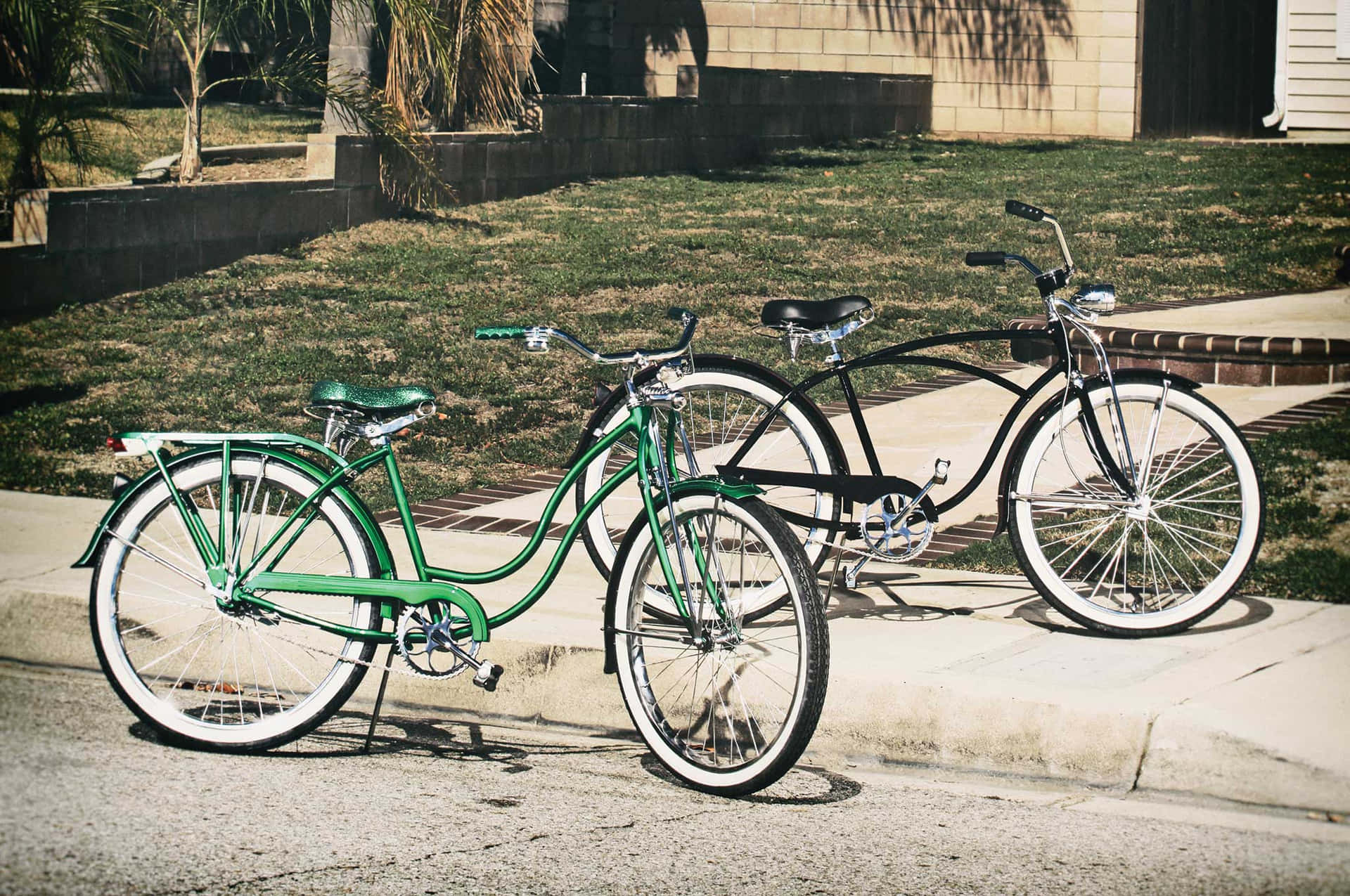 A classic beach cruiser bicycle parked on the shore with the bright ocean waves in the background Wallpaper