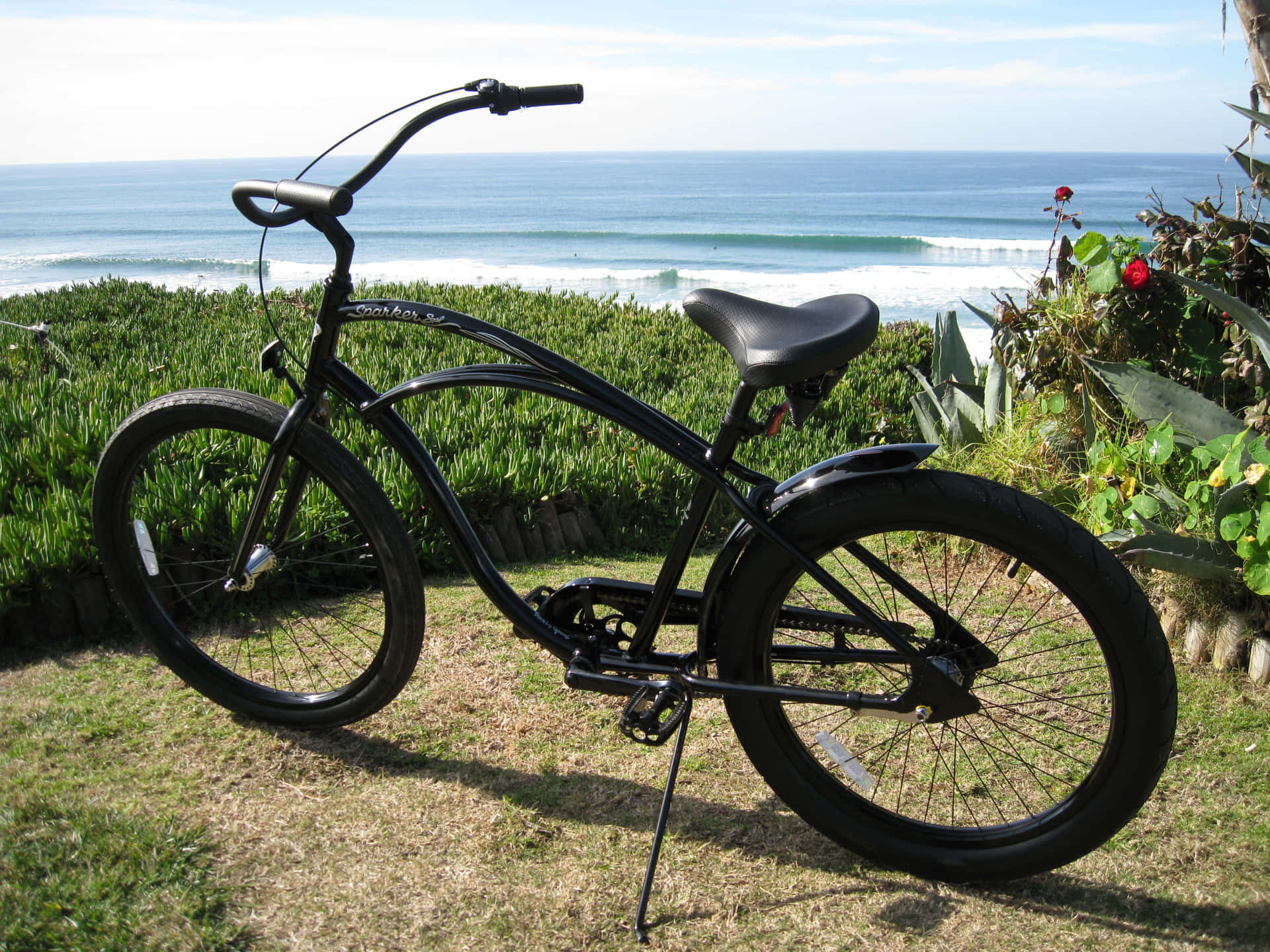 Beach Cruiser Bike on Sandy Coastline Wallpaper