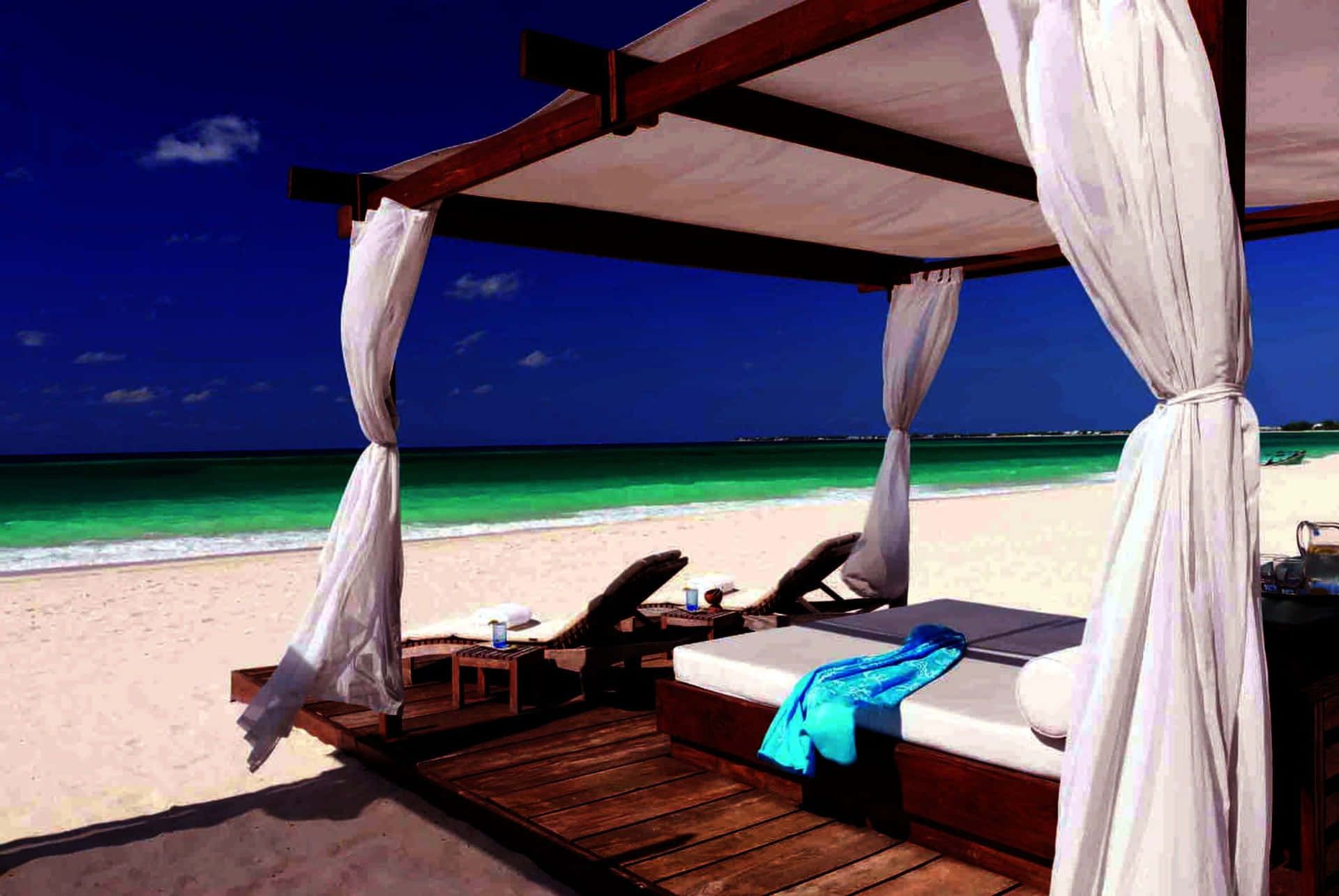 Relaxing Beach Daybed on a Sunny Day Wallpaper