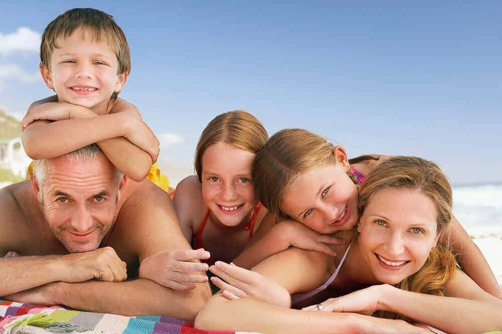 Family On The Beach Laying On The Beach