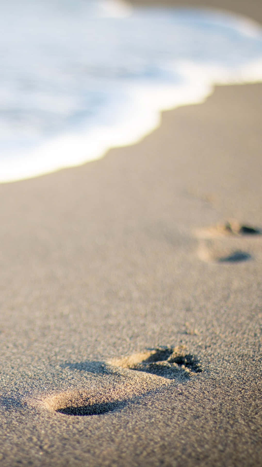 Improntadi Una Spiaggia Sulla Sabbia Sfondo