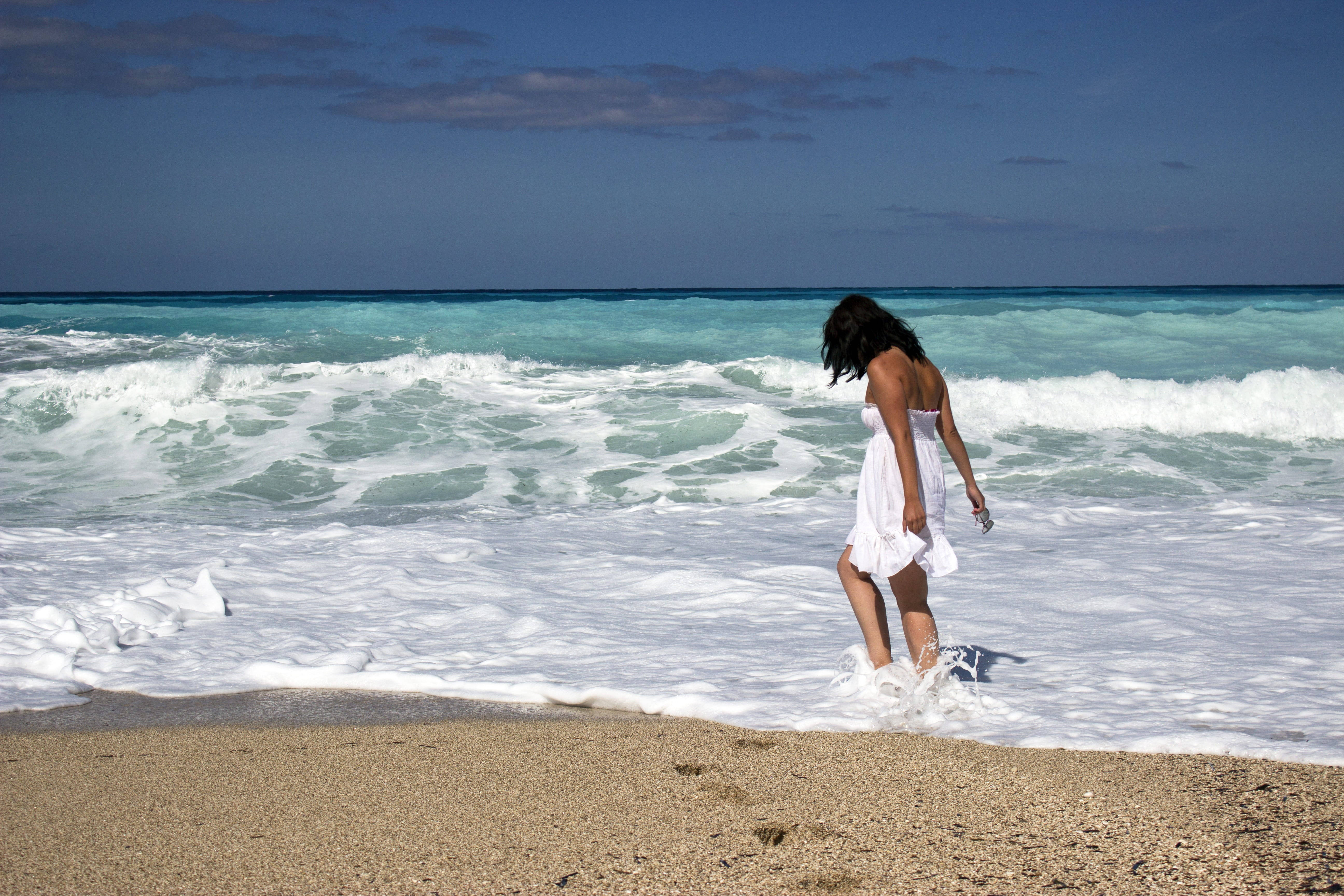 Beach Girl Walking Into Waves Wallpaper