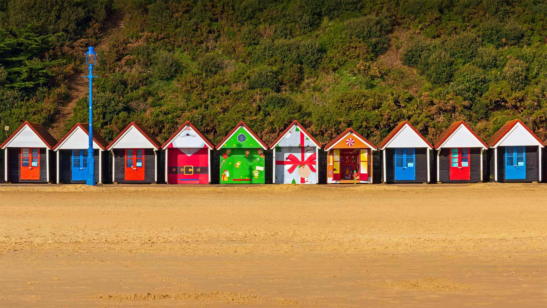 Colorful Beach Huts on the Seashore Wallpaper
