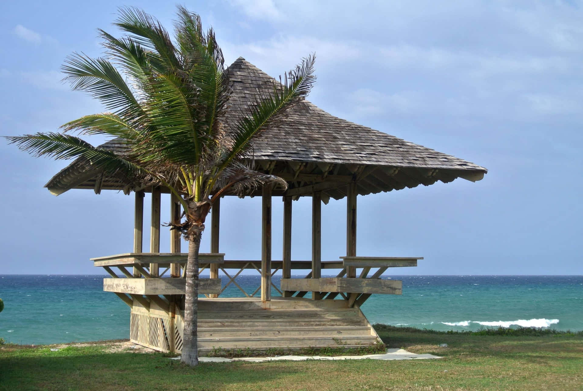 Vibrant beach huts sitting on the picturesque shoreline Wallpaper