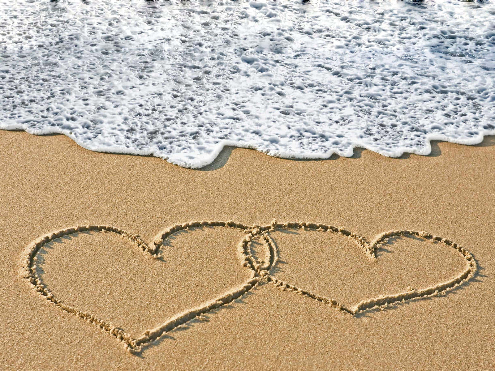 Couple Enjoys a Romantic Beach Sunset Wallpaper